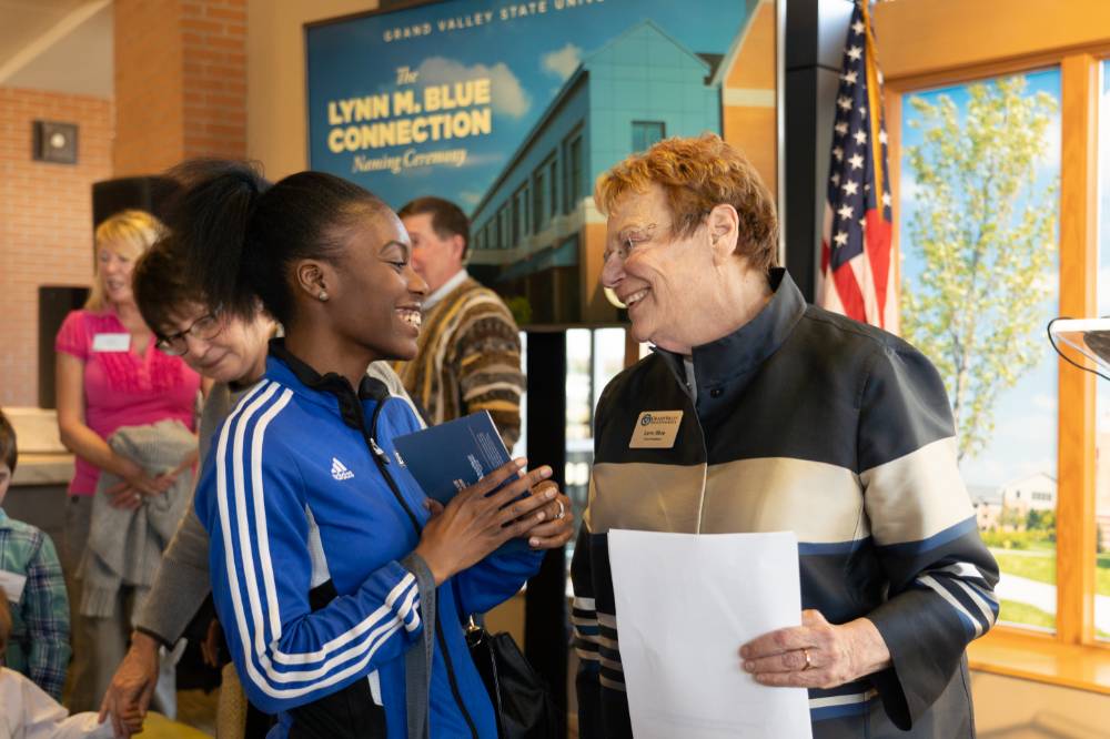 Lynn Blue smiling at a student at the Lynn M. Blue Connection Naming Ceremony